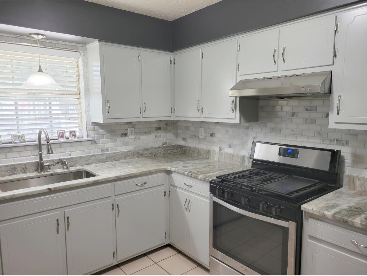 Renovated kitchen with tile backsplash